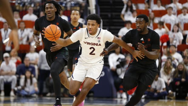 Virginia Cavaliers guard Reece Beekman (2) dribbles the ball away from Miami (Fl) Hurricanes guard Bensley Joseph (4) during the second half at John Paul Jones Arena.
